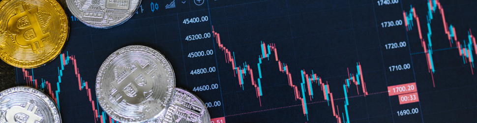 Close up shot of silver and gold coins on a trading chart