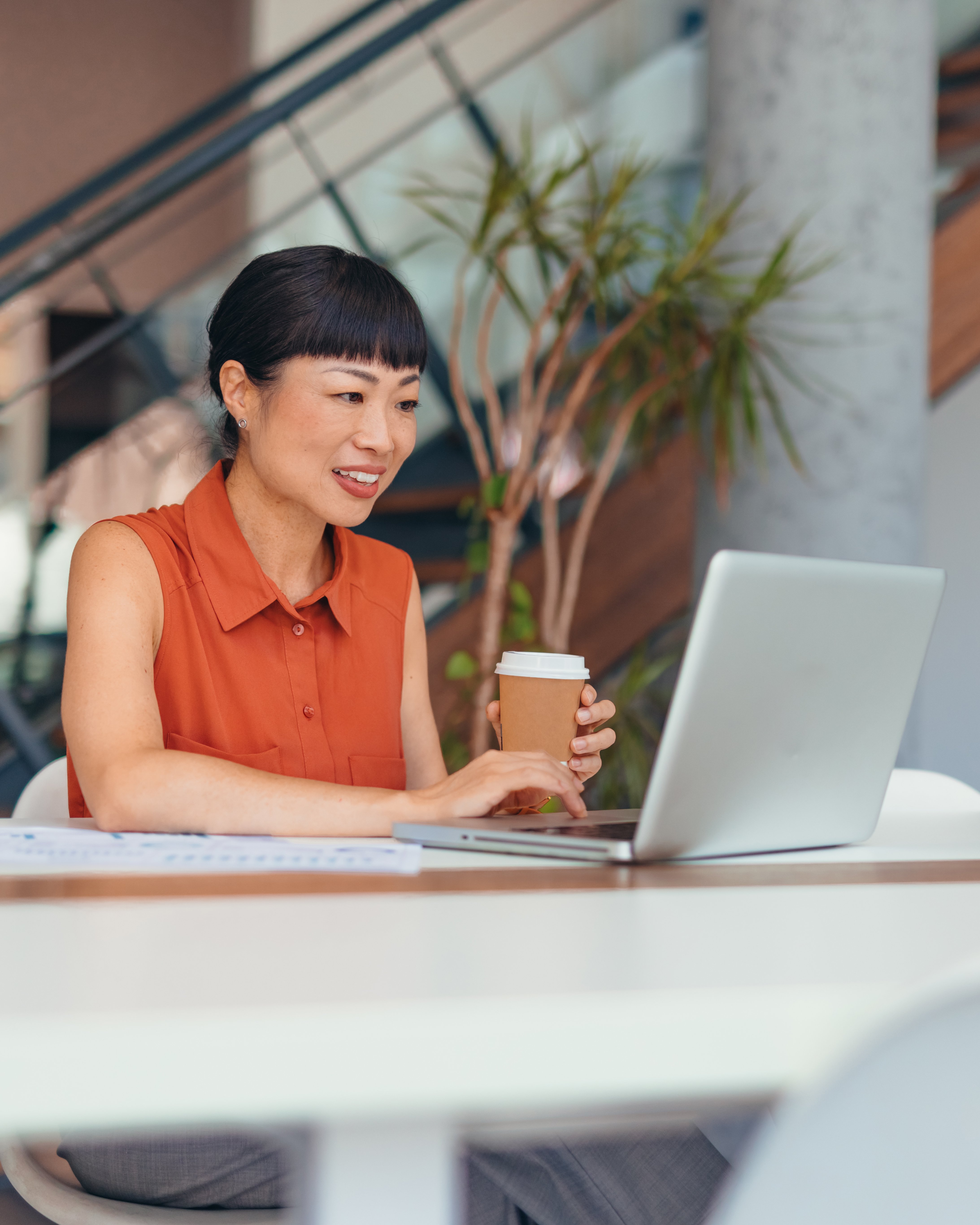 Active trader working on laptop with coffee